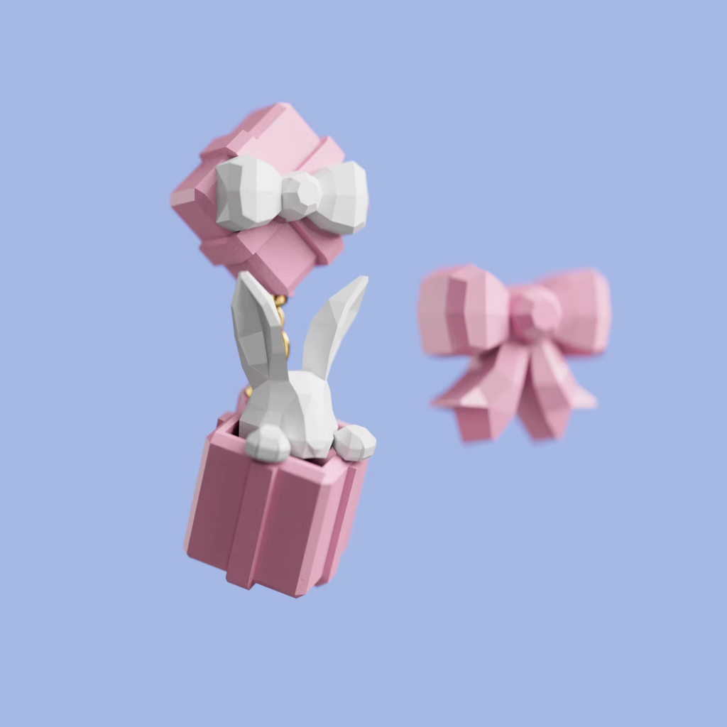 Pastel pink gift box earrings with a white bow and a small bunny figure popping out, cute handmade acrylic jewelry shown from multiple angles