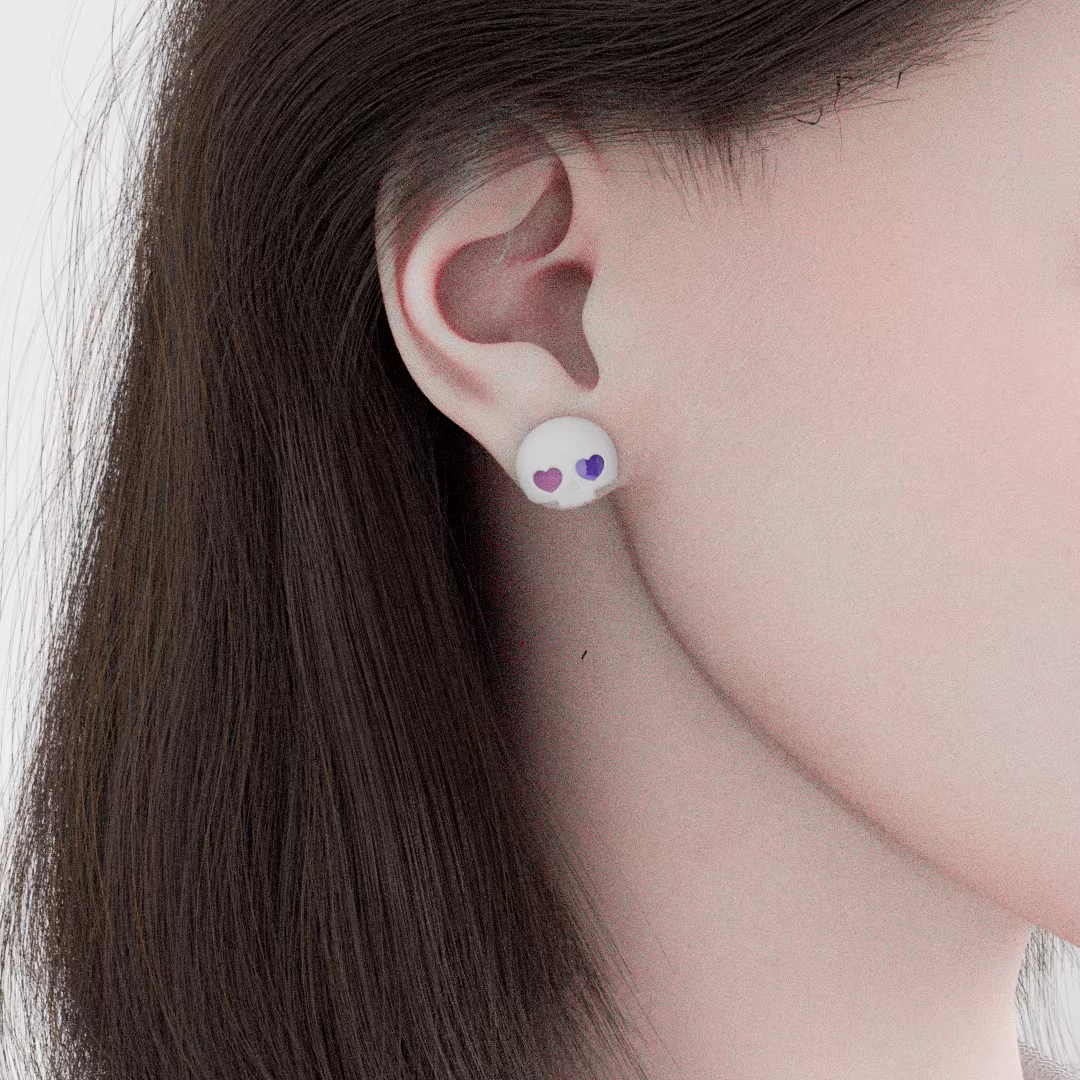 Cute pastel skull stud earrings with heart-shaped eyes, handmade spooky kawaii jewelry worn on ear