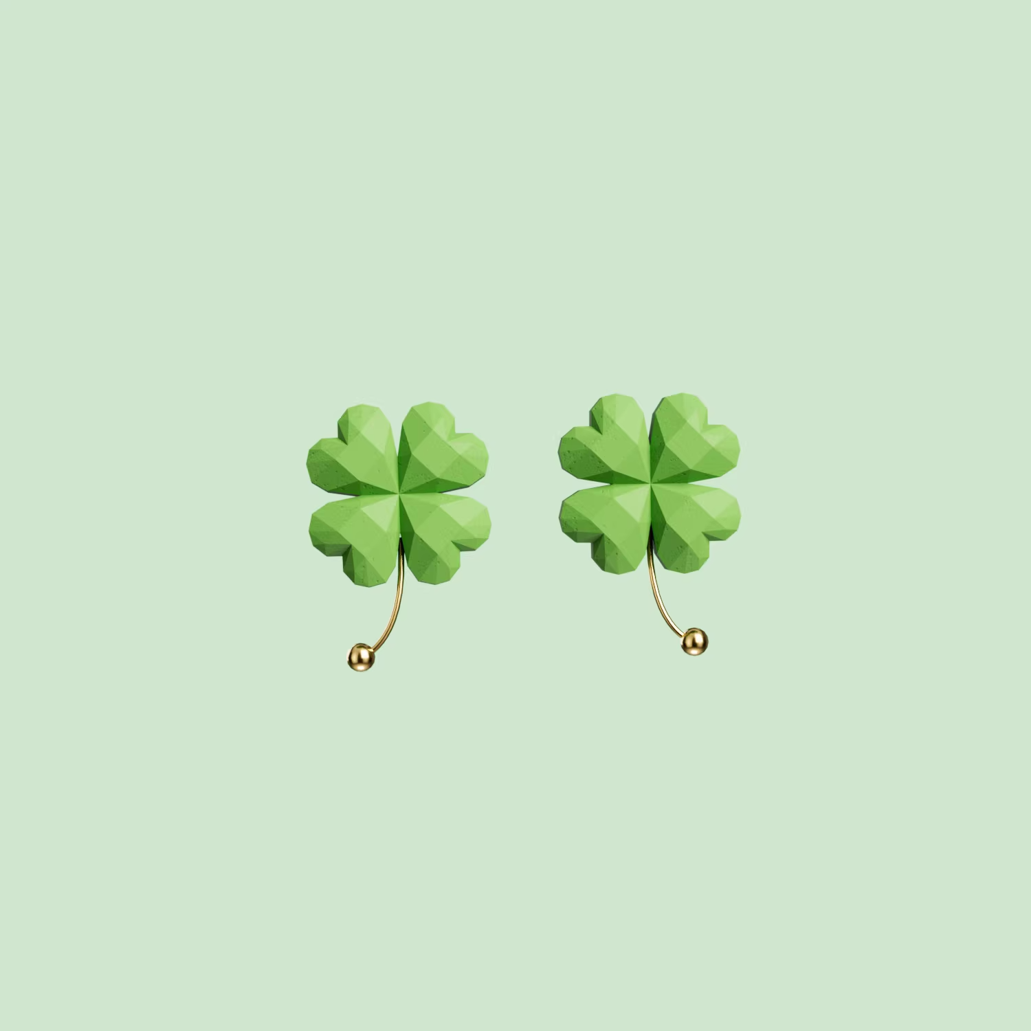 Green four-leaf clover drop earrings with gold accent, lightweight pastel jewelry on soft green background