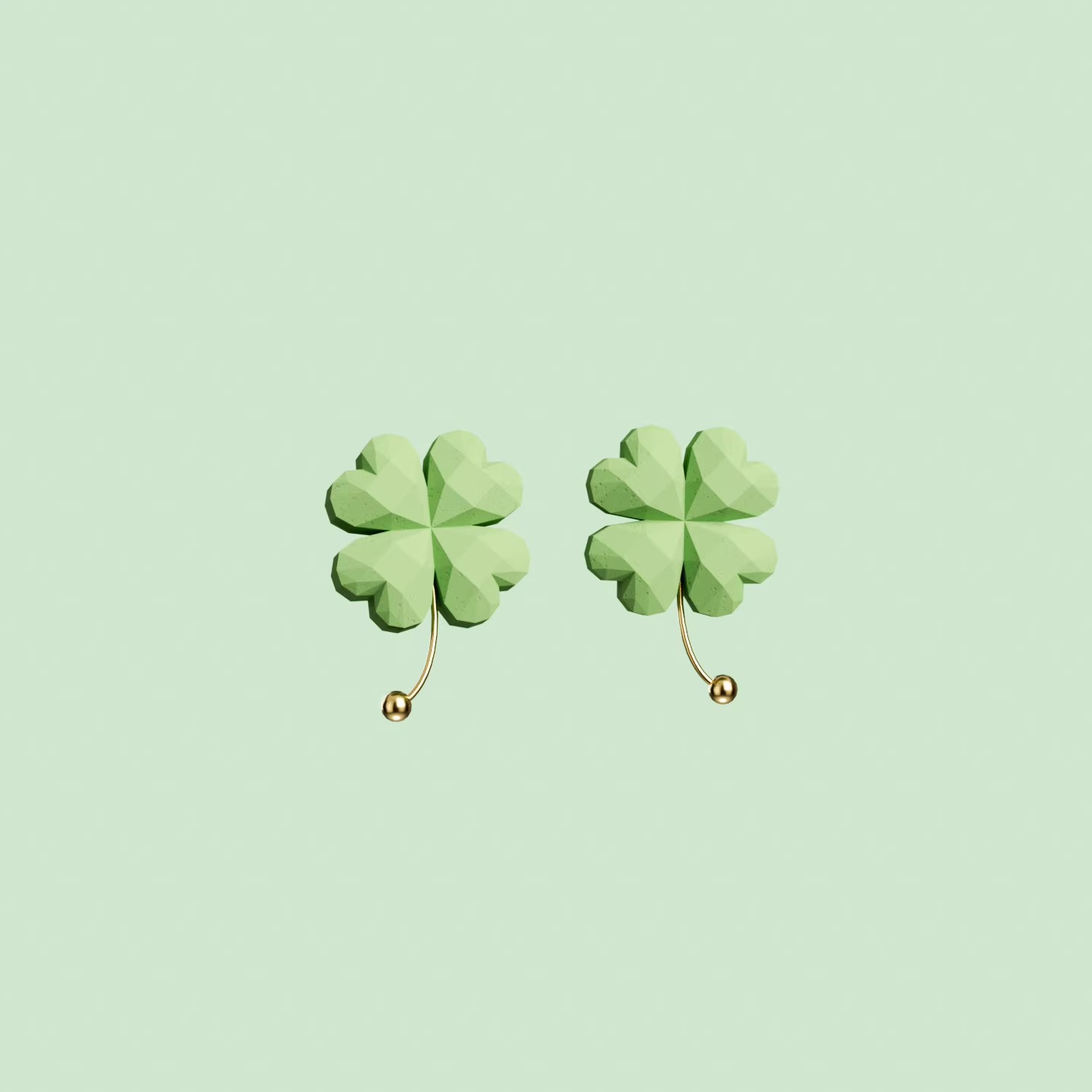 Green four-leaf clover drop earrings with gold accent, lightweight pastel jewelry on soft green background