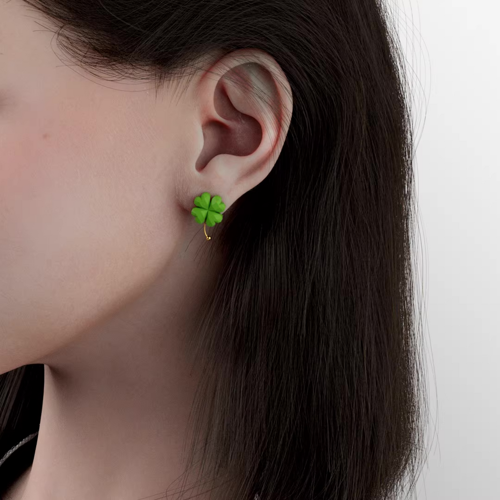 Green four-leaf clover drop earrings with gold accent, lightweight pastel jewelry on soft green background