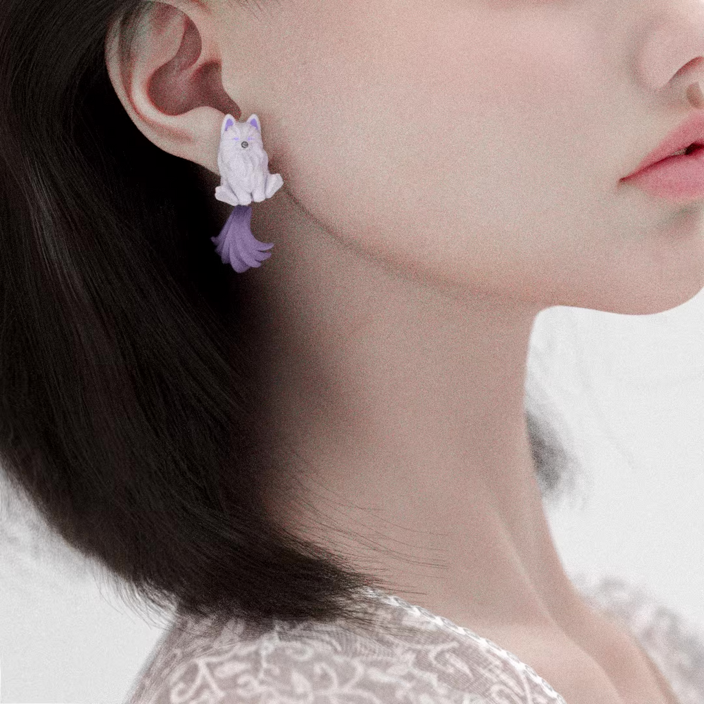 Cute Pomeranian character earrings in pastel colors with fluffy dog design and flowing tail, lightweight handmade jewelry worn on ear.