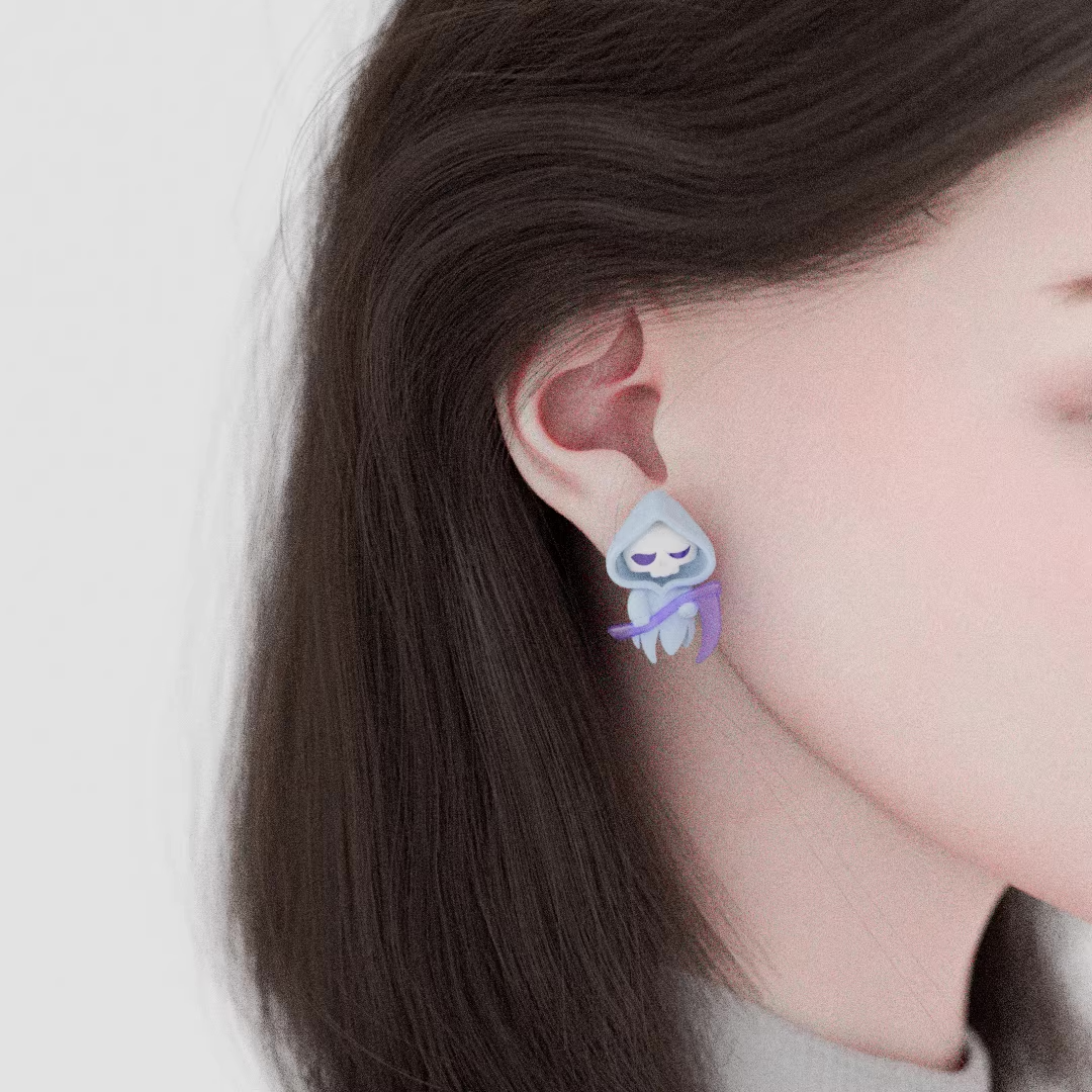 Cute ghost-shaped acrylic earrings featuring a witch ghost and a reaper ghost with pastel purple details, worn as playful statement jewelry